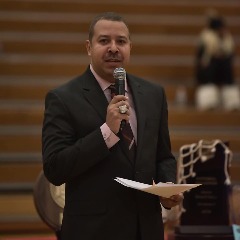 McKinney serving as master of ceremonies for the 2018 Triton College men's basketball teams' national title banner raising ceremony.